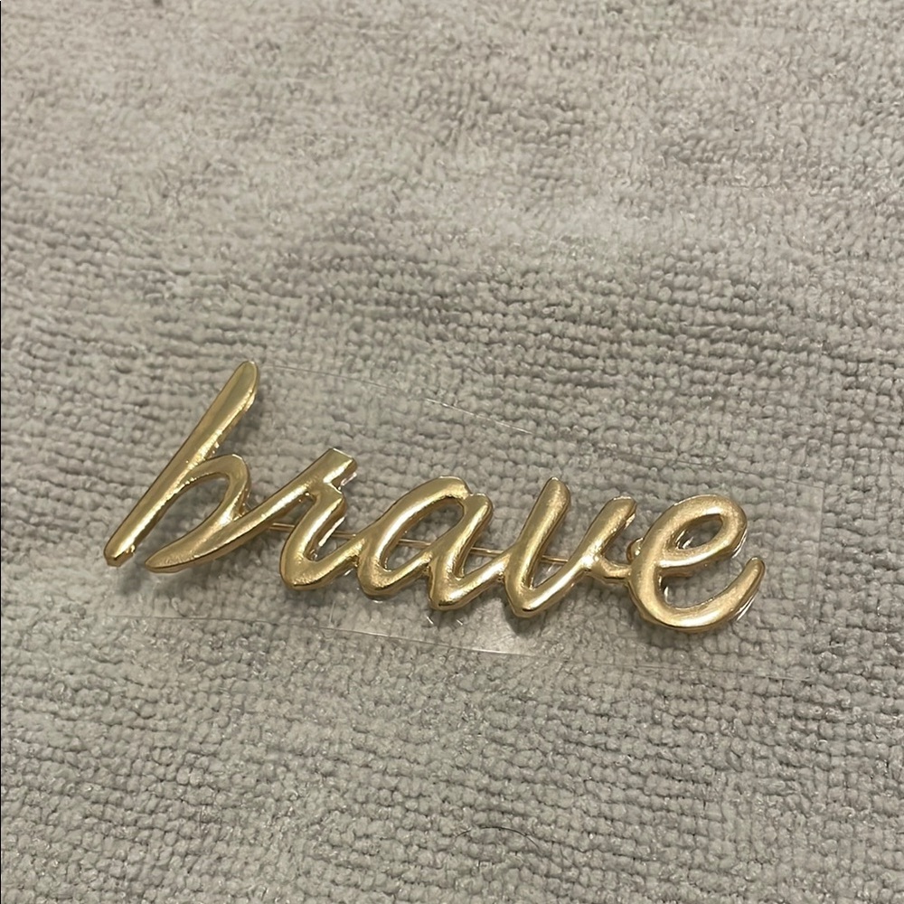 Gold 'Brave' pin